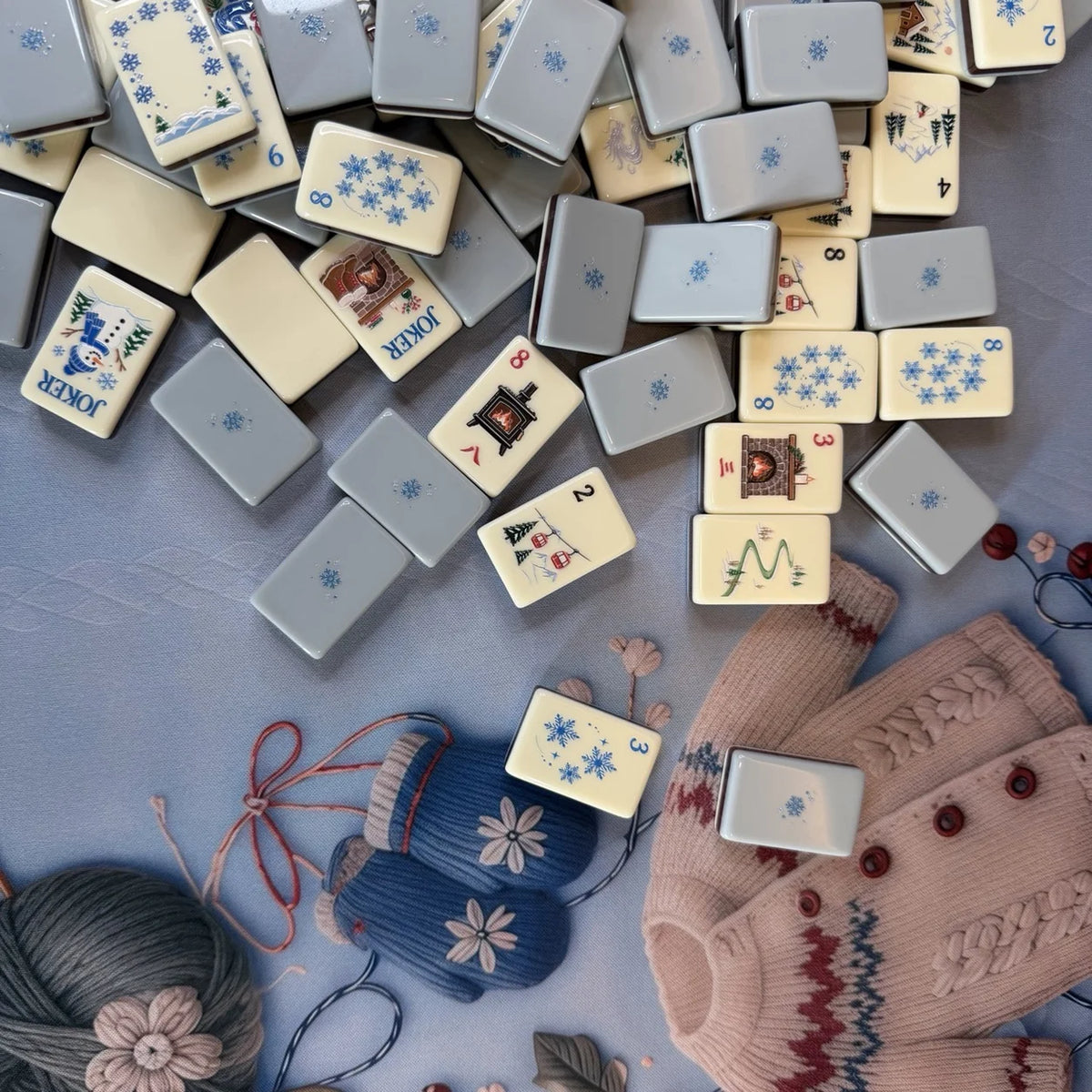 Snowfall Reverie Mahjong tiles showing ivory illustrated faces and powder blue snowflake backs